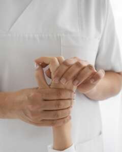 Osteopathist treating patient s arms